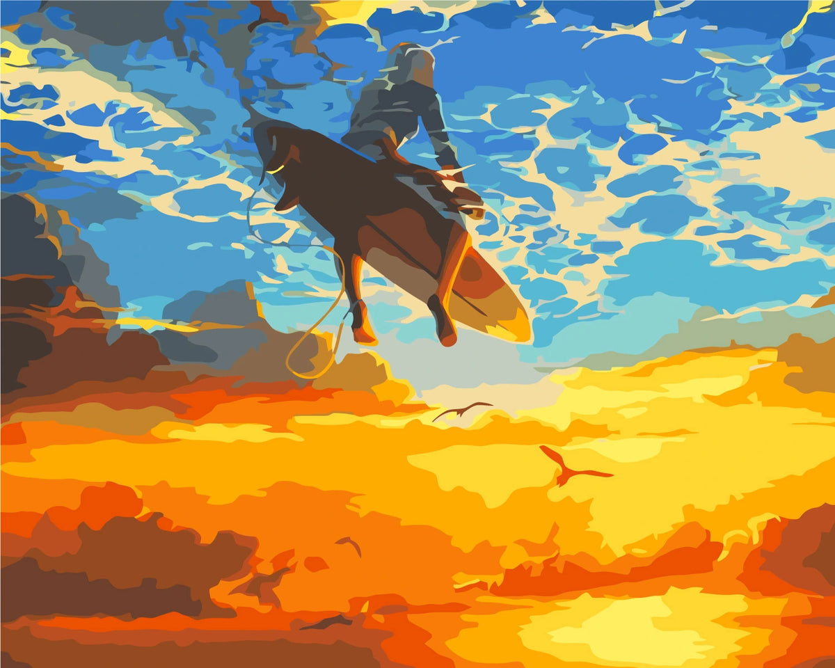 Surfer soaring above the ocean with a vibrant sunset sky