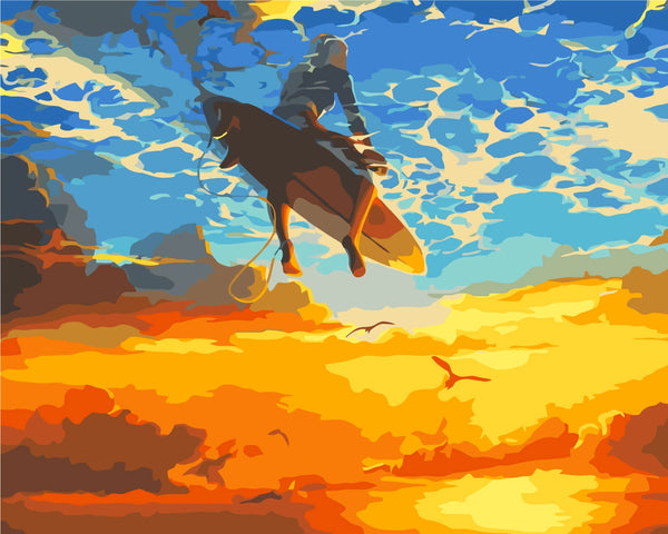 Surfer soaring above the ocean with a vibrant sunset sky