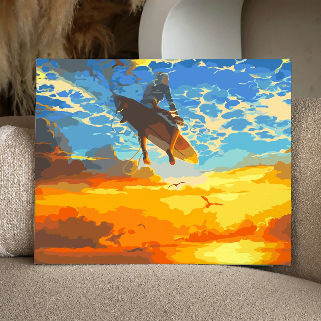 Surfer soaring above the ocean with a vibrant sunset sky