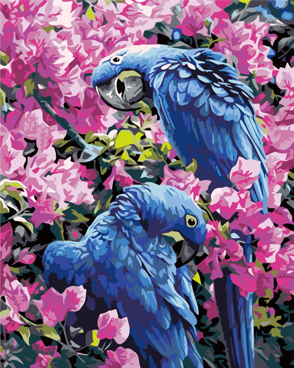 Two vibrant blue parrots perched among lush pink blossoms