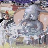 Joyful baby elephant splashing in a water tub at carnival