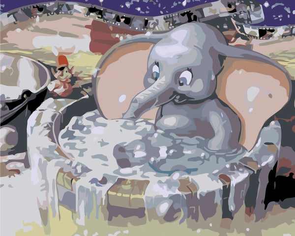Joyful baby elephant splashing in a water tub at carnival