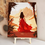 Woman in flowing red dress walking through a desert landscape