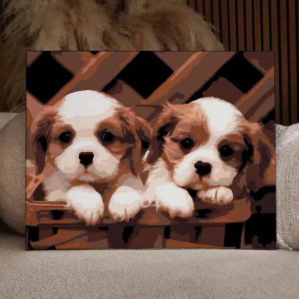 Painting of two Cavalier King Charles Spaniel puppies in a basket