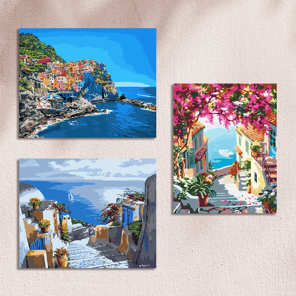 Paintings of colorful coastal villages with ocean views and flowers
