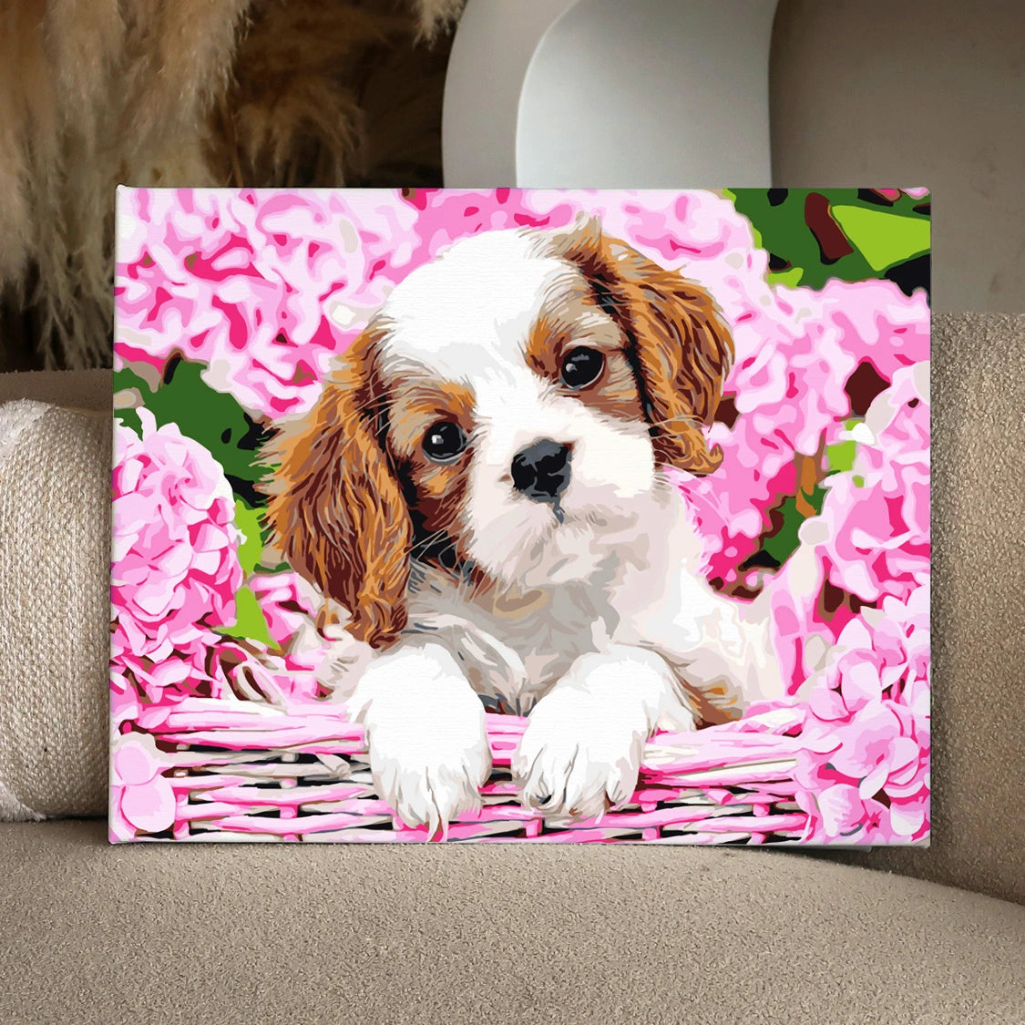 Adorable puppy in basket surrounded by pink hydrangea flowers