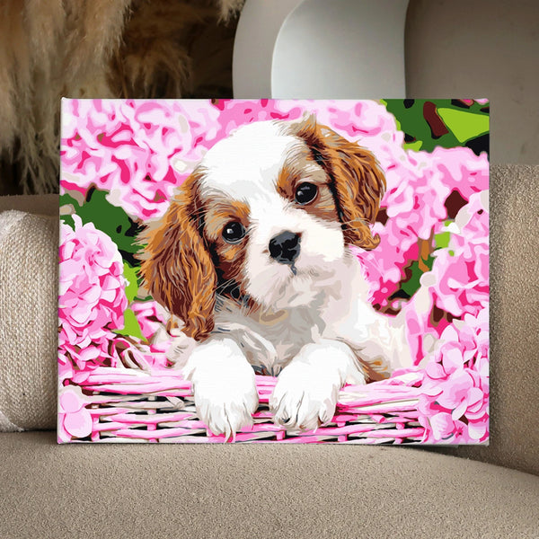 Adorable puppy in basket surrounded by pink hydrangea flowers