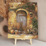 Rustic wooden door with vintage bicycle and potted flowers