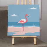 Pink flamingo standing on a sandy beach with ocean waves