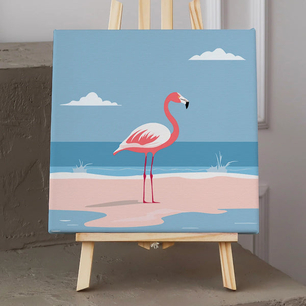 Pink flamingo standing on a sandy beach with ocean waves