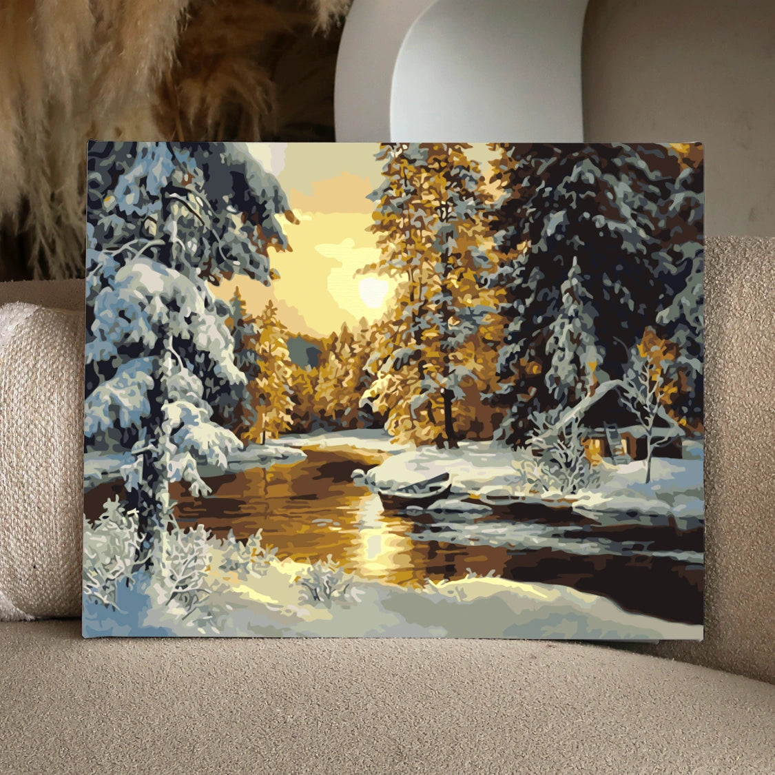 Winter landscape painting with snow-covered trees and golden sunset