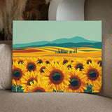 Vibrant sunflower field with rolling hills and mountains in background