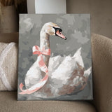 Elegant white swan with a pink ribbon on a gray background