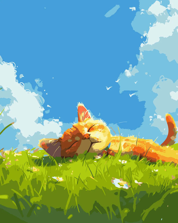 Orange cat relaxing on a grassy field under a blue sky