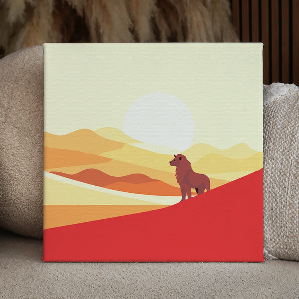 A lion standing on a hill against a desert sunset