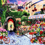 Colorful European street market with flowers, bicycles, and historic buildings
