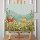 Cute yellow duckling in a flower meadow with Easter basket