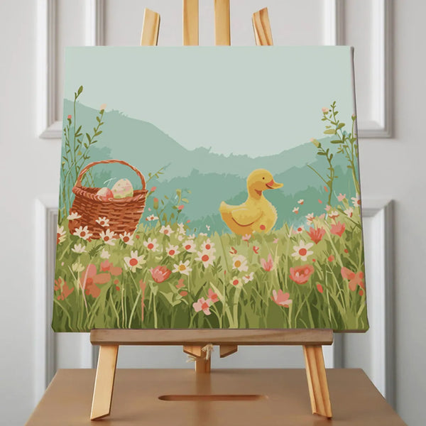 Cute yellow duckling in a flower meadow with Easter basket