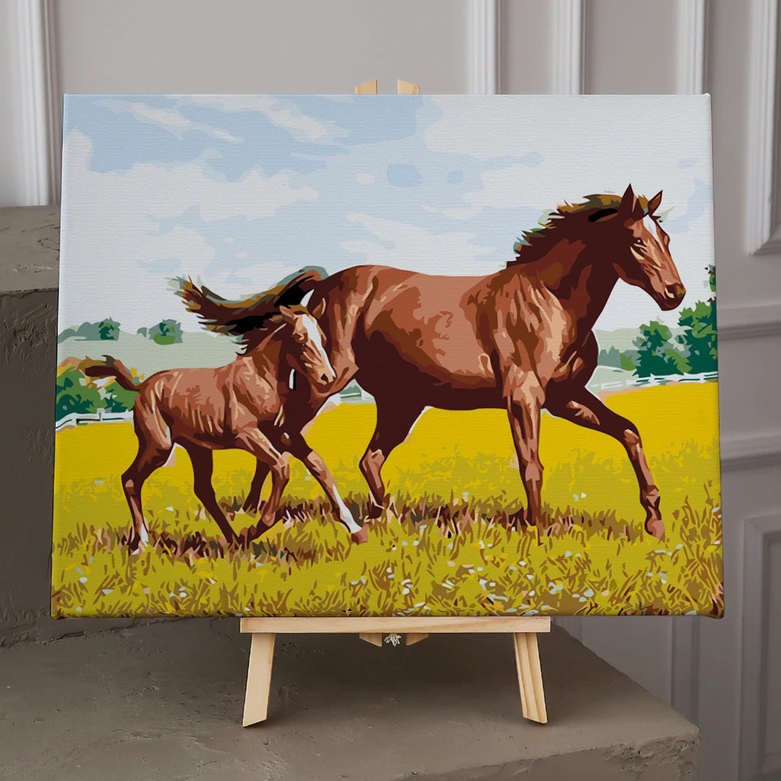 Mother horse and foal running through a sunny meadow