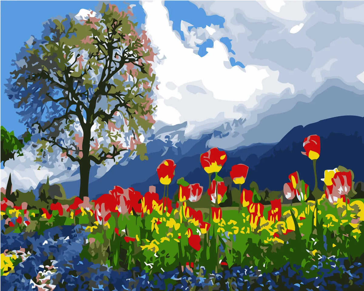 Vibrant tulip field with a tree and mountain backdrop