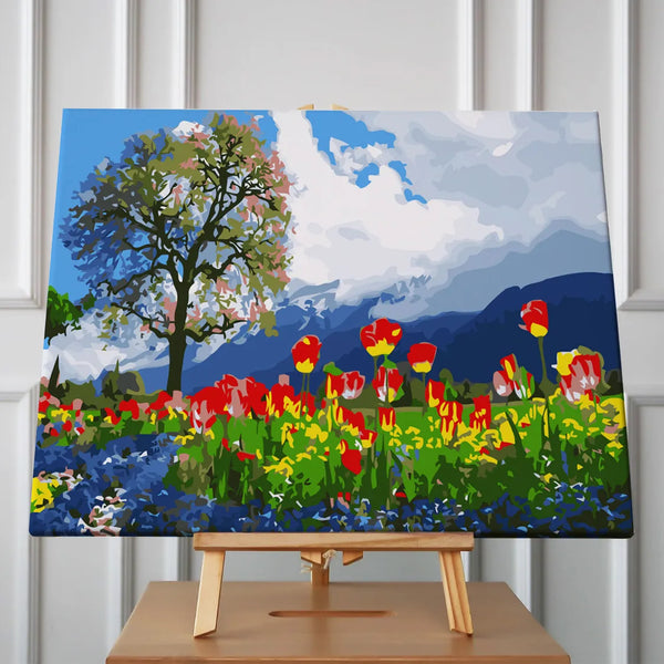 Vibrant tulip field with a tree and mountain backdrop
