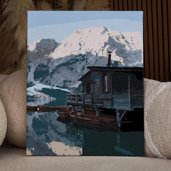 Rustic cabin by a mountain lake with wooden boats