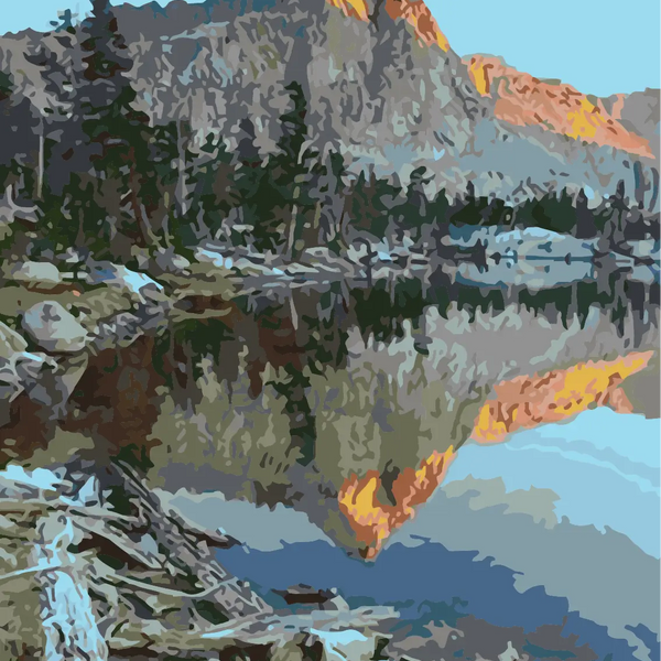 Mountain landscape reflecting in a calm lake at sunrise