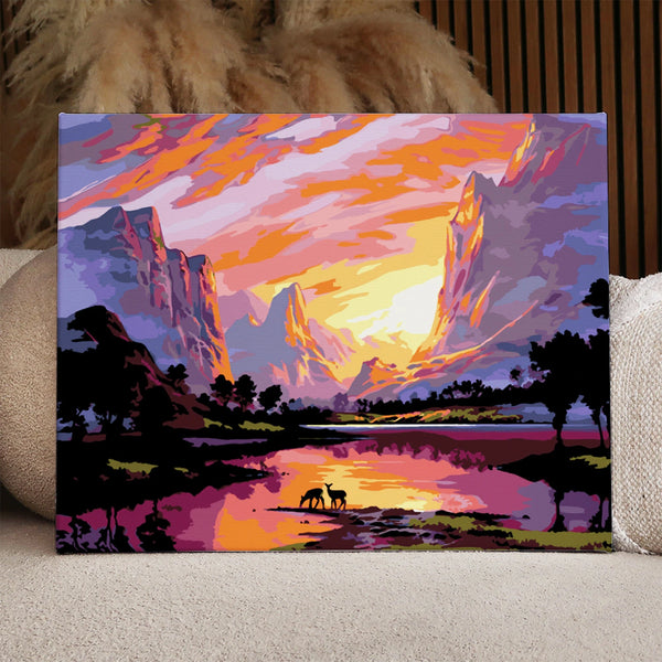 Majestic sunset over mountains with deer by a reflective lake