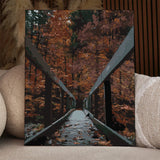 Painting of a wooden bridge surrounded by autumn trees and leaves