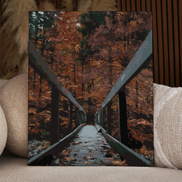 Painting of a wooden bridge surrounded by autumn trees and leaves