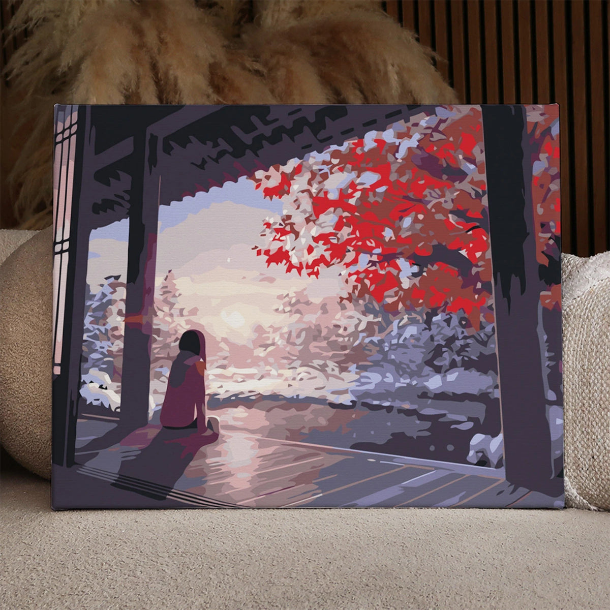 Painting of a woman sitting on a porch admiring winter scenery