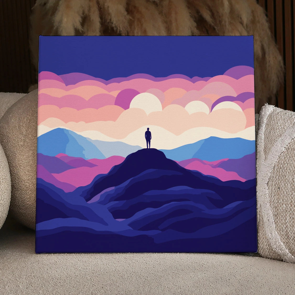 Silhouette of person standing on mountain peak under colorful sky