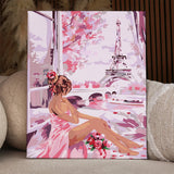 Romantic painting of a woman in pink overlooking Eiffel Tower