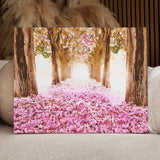 Tree-lined pathway with pink flower petals and soft sunlight painting