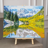 Mountain landscape with pine trees, lake reflection, and autumn colors painting