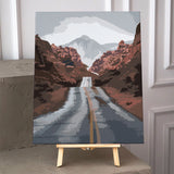 Desert highway leading to mountains with cloudy sky painting