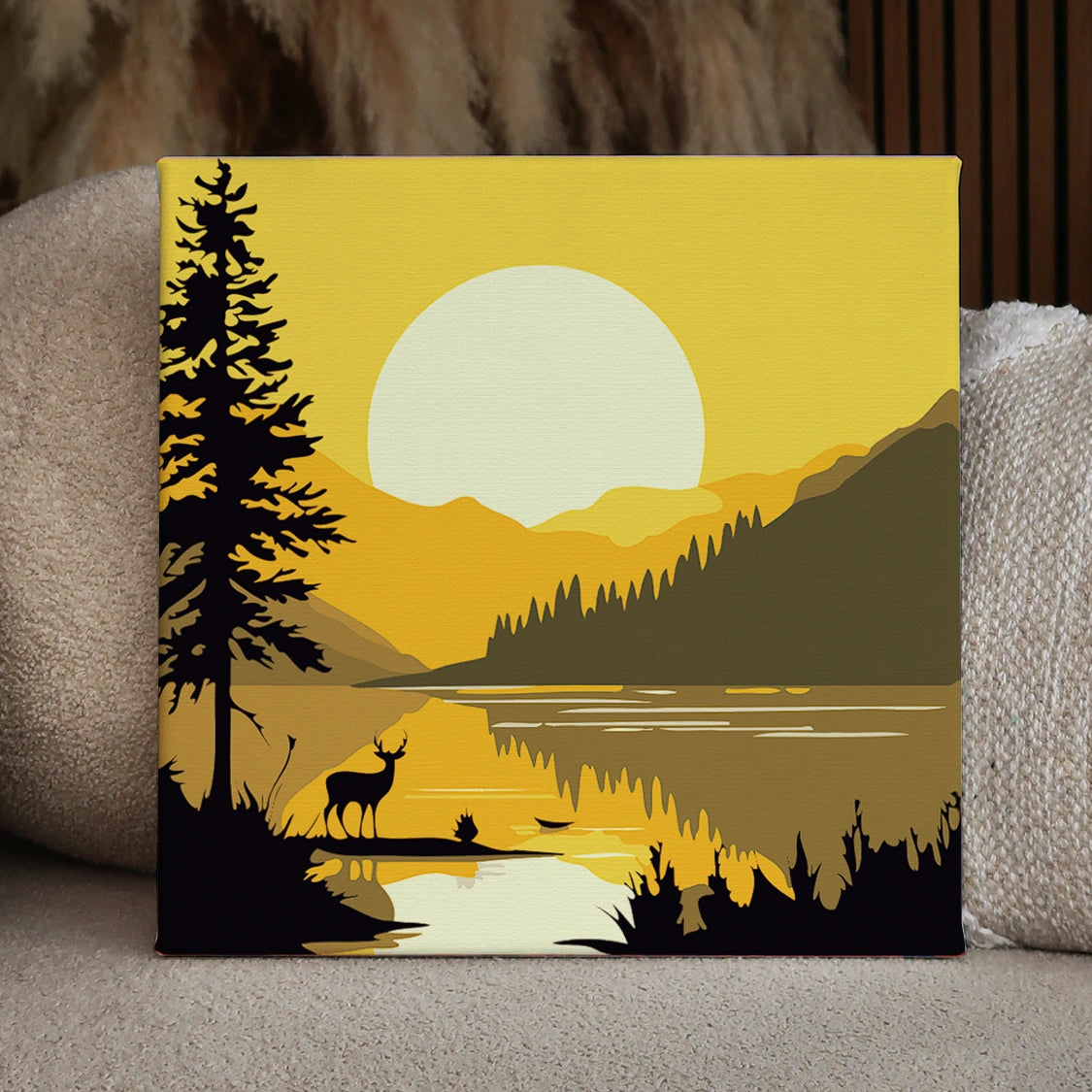 Silhouette of a deer by a lake with sunset mountains