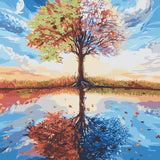 Tree representing four seasons reflected in a tranquil lake