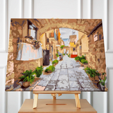 Painting of a charming Mediterranean alley with stone walls and plants
