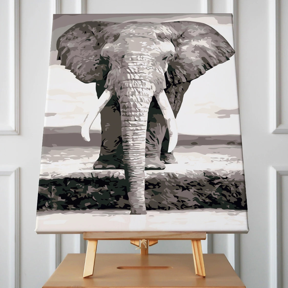 Stylized black and white painting of an elephant near water