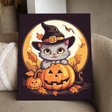Cute Halloween cat wearing a witch hat inside a pumpkin