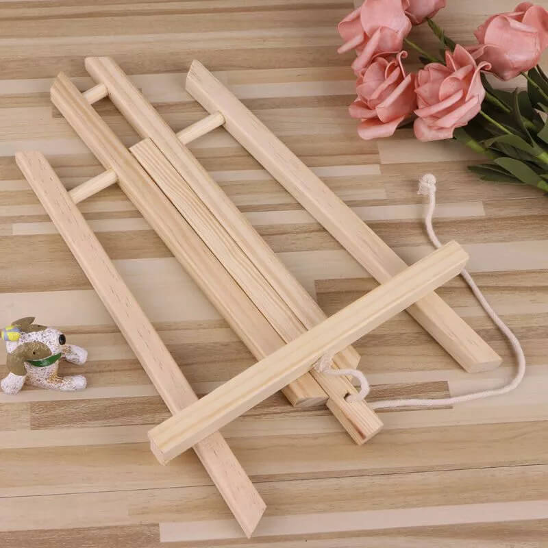Folded pine wood easel on a wooden surface – compact storage