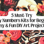 paint by numbers featuring paint brushes, paint pots, a skull painting, flower girl painting and a text 