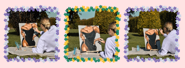 A woman sitting on a blanket outdoors, painting a canvas that depicts a figure in a black dress. 