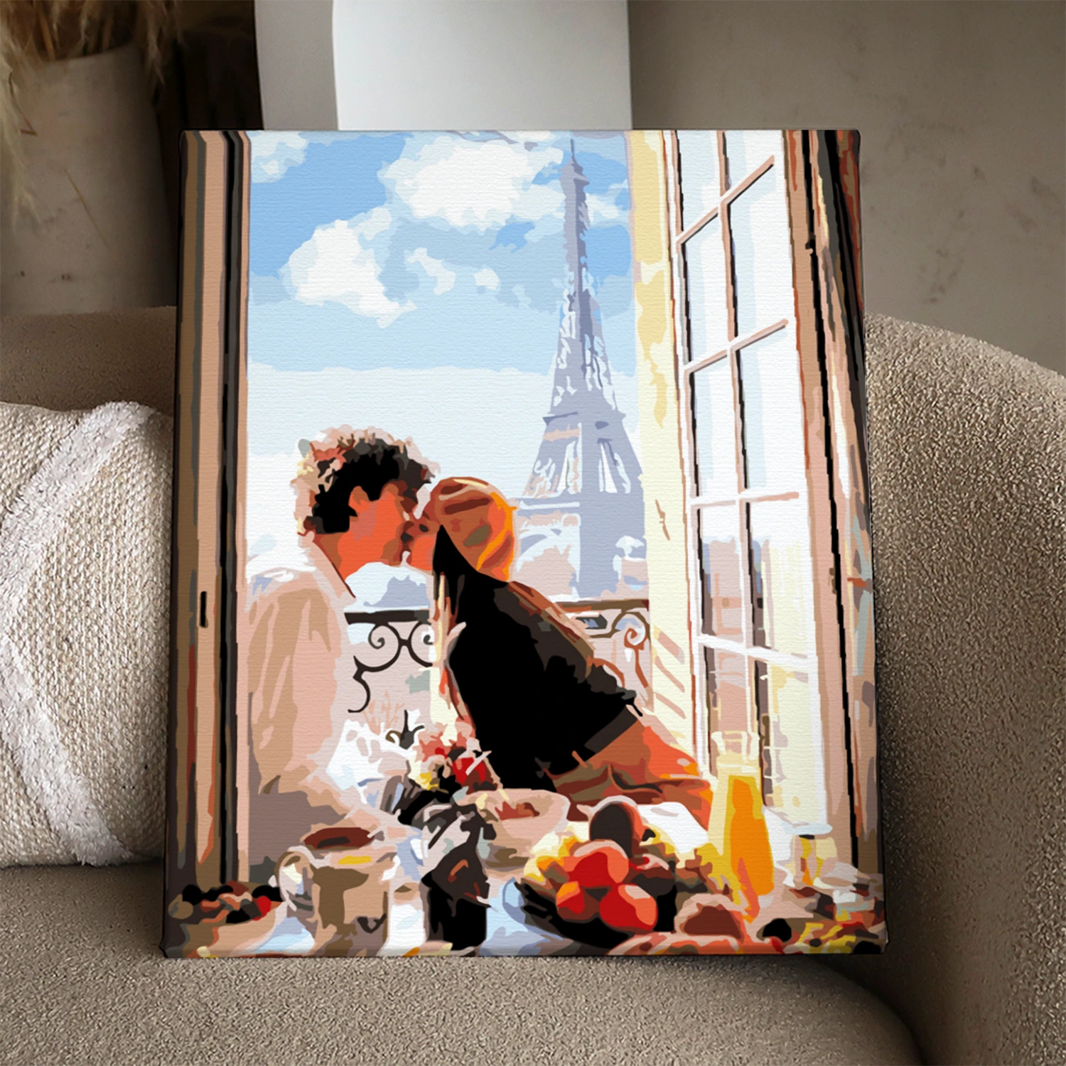 Stylized painting of a couple kissing at a Parisian balcony breakfast