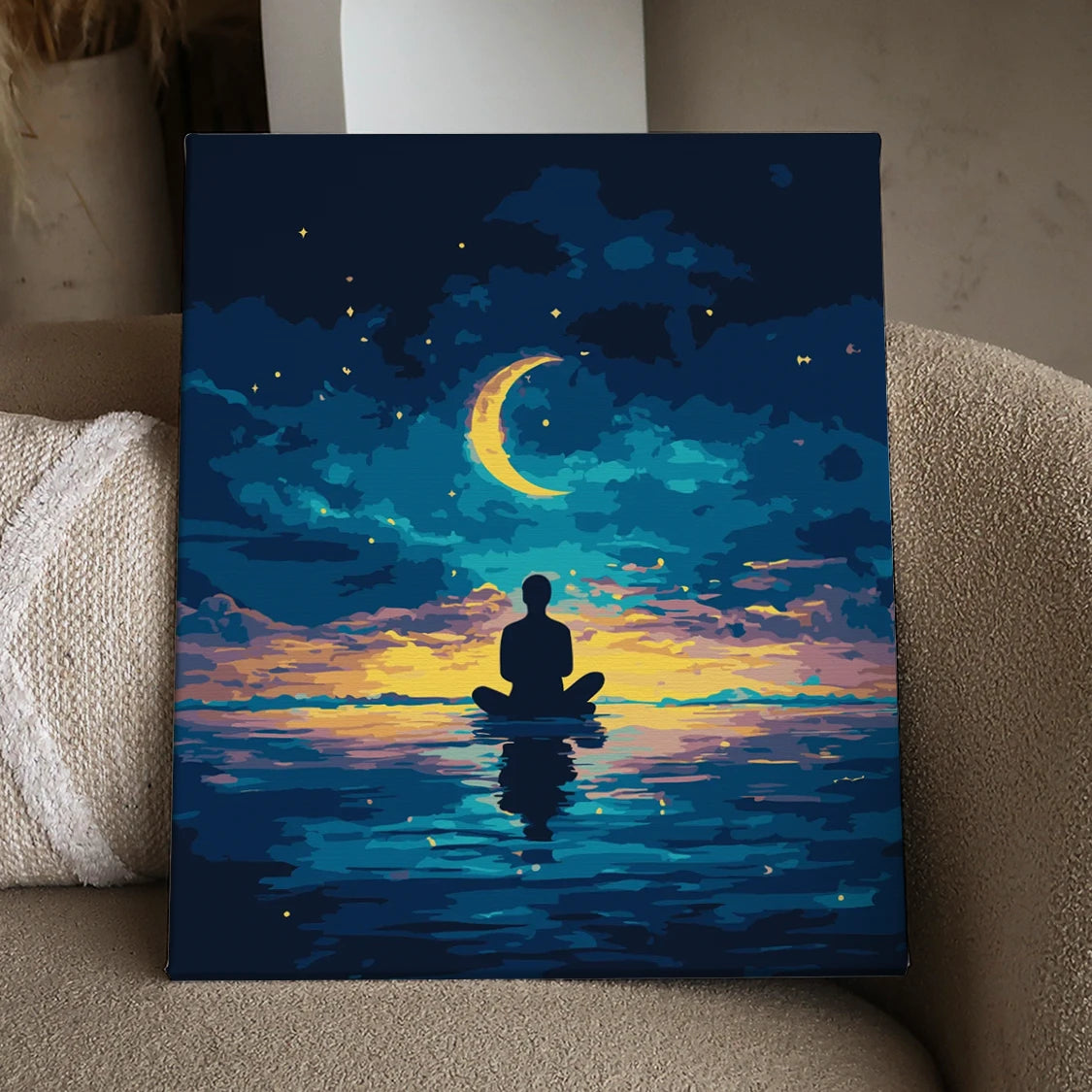 Silhouetted figure meditating on water under a glowing crescent moon and twilight sky, featured in the A Soul at Peace paint by numbers kit.