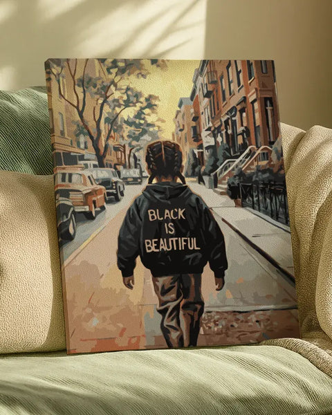 Finished Black Is Beautiful paint by numbers artwork showing a person walking through a city street wearing a statement jacket