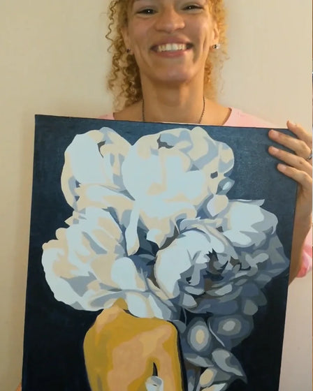 ArtSpark customer with their finished paint by numbers canvas