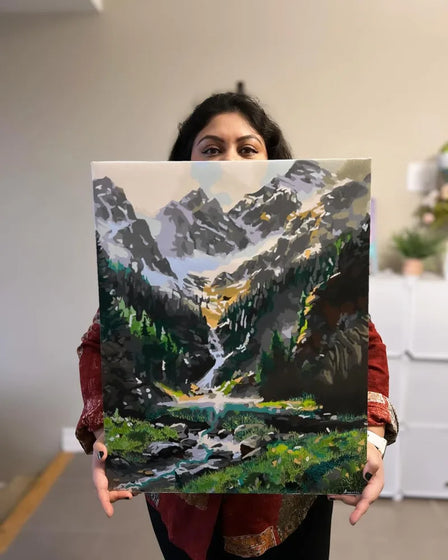 ArtSpark customer with their finished paint by numbers canvas