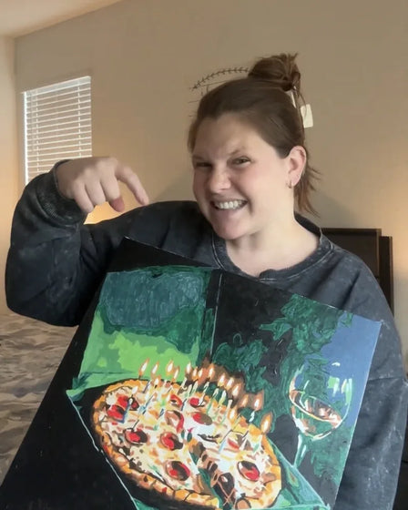 ArtSpark customer with their finished paint by numbers canvas